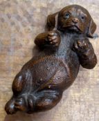A decorative Continental Black Forest style carved wood figure of a dog with inset glass eyes (