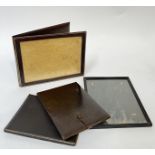 A group of embossed and gilt leather items comprising three portable picture frames with folding