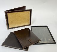 A group of embossed and gilt leather items comprising three portable picture frames with folding