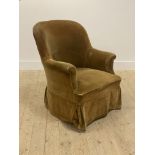 A late Victorian yellow velvet upholstered tub chair, raised on square tapered supports and brass