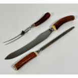 An Epns horn handled three piece carving set including fork, carving knife and steel, missing box