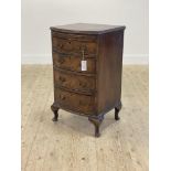 A George II style walnut bedside bow front chest, first half of the 20th century, the cross banded