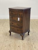 A George II style walnut bedside bow front chest, first half of the 20th century, the cross banded