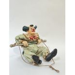 A large composite decorative hanging clown ornament, painted in bright colours, signed 'Jun Asilo