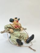 A large composite decorative hanging clown ornament, painted in bright colours, signed 'Jun Asilo
