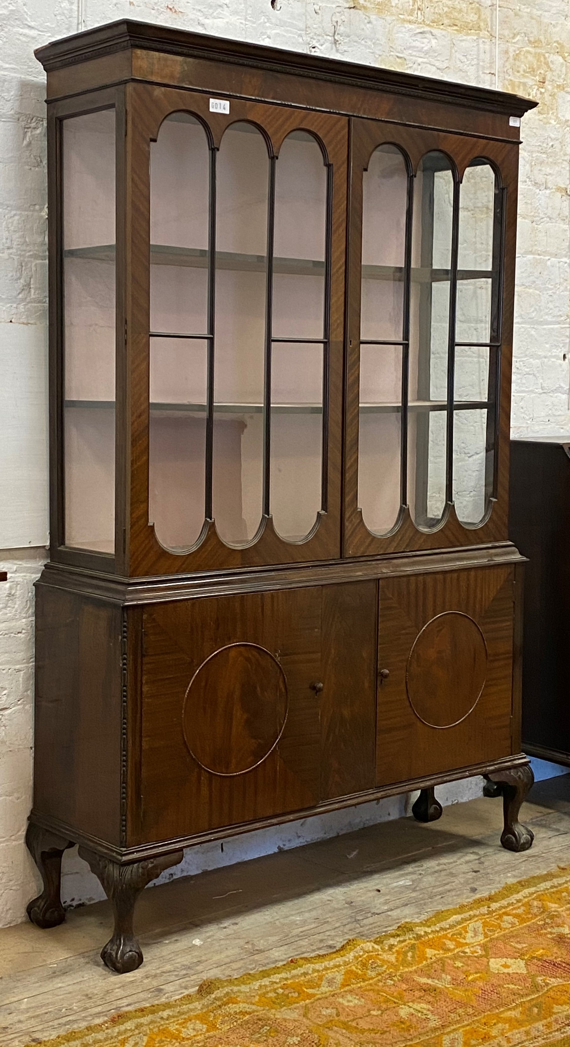 A George III style mahogany bookcase, two glazed doors opening to two fixed shelves, twin panelled