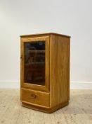 Ercol, a glazed blonde elm cabinet, the interior fitted with two shelves over a drawer H93cm, W56cm,