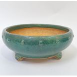 A modern Chinese green crackle glazed circular pottery planter with studded decoration, on three