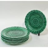 A set of eight Wedgwood green glazed moulded majolica plates of sunflower form (Wedgwood impressed