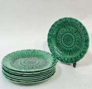 A set of eight Wedgwood green glazed moulded majolica plates of sunflower form (Wedgwood impressed