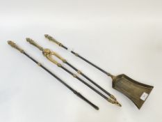 A trio of brass and iron fireside companions in the Regency style, L66cm