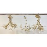 A pair of white painted aluminium multi branch chandeliers formed as inverted tulip bouquets, with