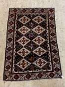 A Persian Yalameh style rug, the abrashed field of repeating lozenge design and bordered 199cm x