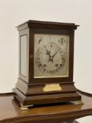 An Edwardian mahogany cased ting tang bracket clock, with bevelled glass to all sides, on brass