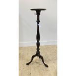 A Georgian style mahogany torchere, circular top over baluster turned column, triple splay supports,