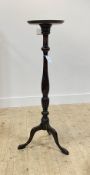 A Georgian style mahogany torchere, circular top over baluster turned column, triple splay supports,