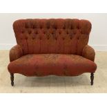 A Victorian style two seat sofa, possibly Derwent, upholstered in a deep red floral and buttoned