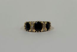 A sapphire and diamond ring, probably early 20th century, the three oval-cut graduated dark blue