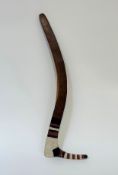 An Australian Aborigine hooked boomerang, with painted decoration, bands of black, white and red