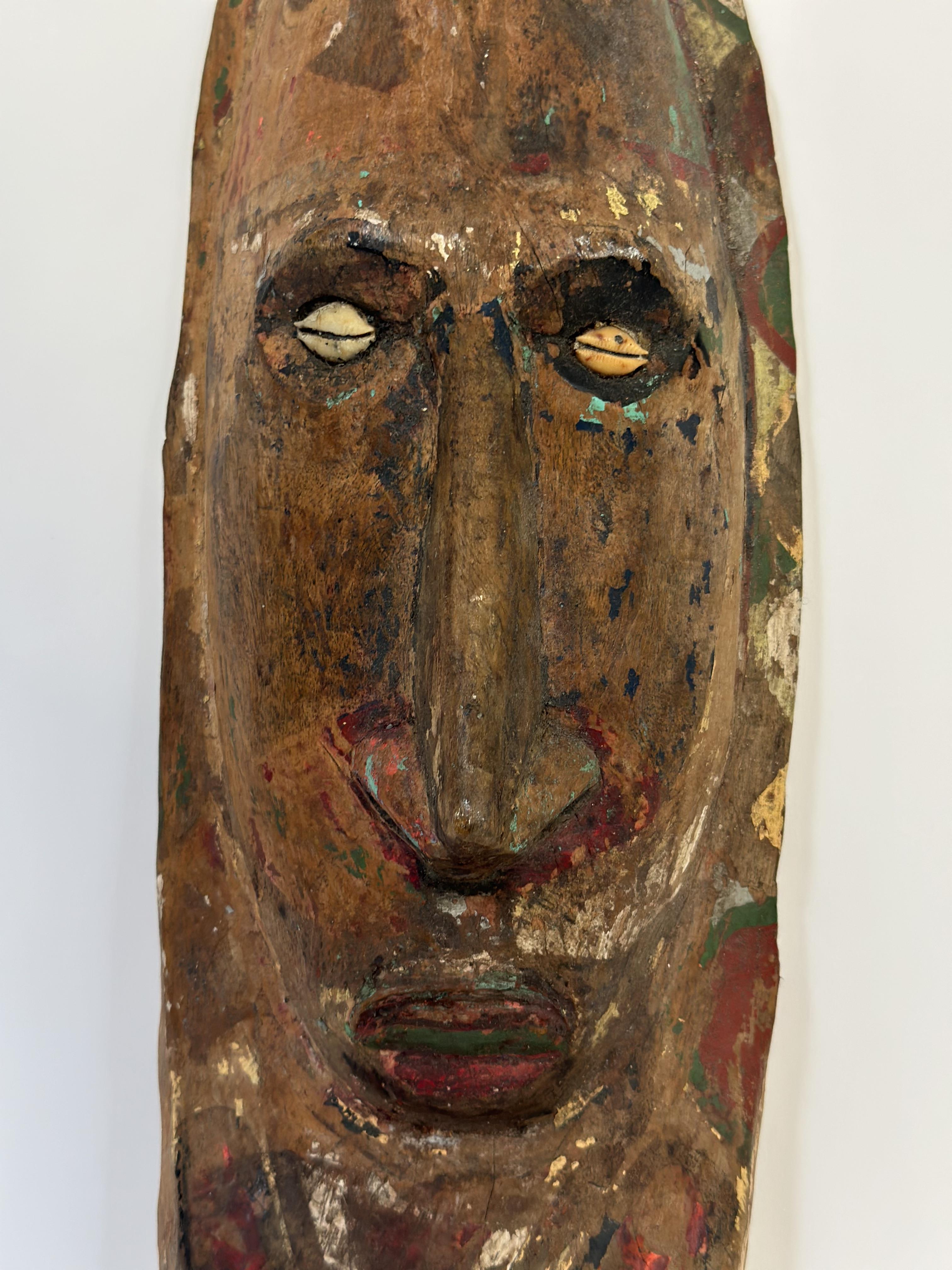 A painted wooden wall mask, Papua New Guinea, with cowrie shell eyes. Height 41cm - Image 2 of 3