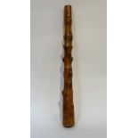 A substantial knotted wooden club, of tapering cylindrical form. Length 88cm