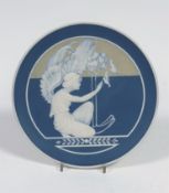 A Villeroy & Boch, Mettlach, pate sur pate wall plate, early 20th century, decorated with a kneeling