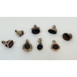 A group of eight 19th century seals and fobs, each mounted in unmarked yellow metal including