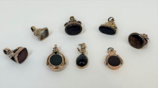 A group of eight 19th century seals and fobs, each mounted in unmarked yellow metal including