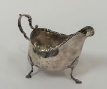 A George III Irish silver sauce boat, Matthew West, Dublin, 1787, of oval bellied form, with leaf-