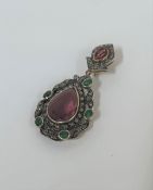 An Indian ruby, emerald and diamond pendant, the drop centred by a pear-cut ruby within a pierced