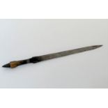 A long African dagger, the steel blade with metal-mounted horn grip, in a leather sheath. Length