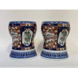 A pair of Chinese porcelain garden seats, 20th century, of waisted barrel form, painted in an