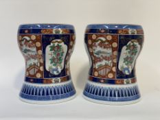 A pair of Chinese porcelain garden seats, 20th century, of waisted barrel form, painted in an