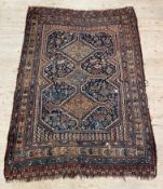 An antique Persian Quashgai rug, the blue field with geometric pole medallion having stylised