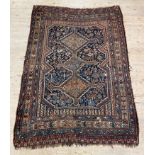 An antique Persian Quashgai rug, the blue field with geometric pole medallion having stylised