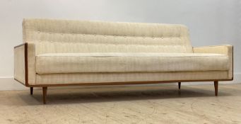 A Danish 1960's sofa/ daybed, upholstered in ivory white chenille type button back fabric, with