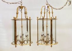A pair of gilt lacquered brass four branch hall lanterns of cylindrical outline, second half of