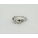 A single stone diamond ring, the round brilliant-cut stone weighing c. 0.9ct, claw-set on