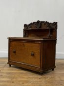 A Victorian oak table secretaire, the raised back with floral carved pediment centred by a