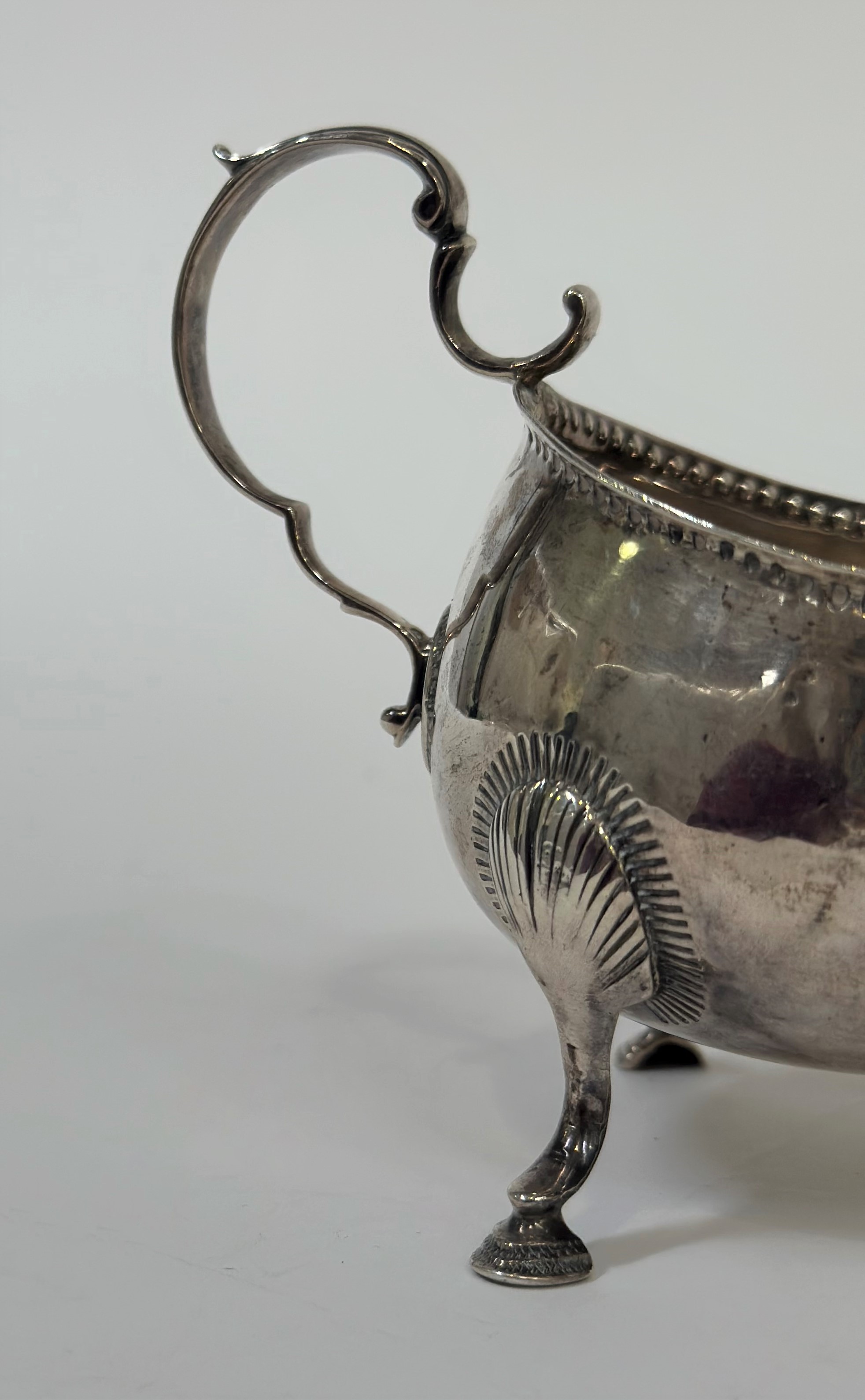 A George III Irish silver sauce boat, Matthew West, Dublin, 1787, of oval bellied form, with leaf- - Image 2 of 3