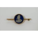A 9ct gold bar brooch, centred by a an earlier blue jasperware cameo plaque of the bust of an 18th