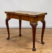 A George II walnut fold over card table, the bur, cross banded, and ebony strung top with lobed