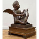 A large patinated metal figure of a putto playing a lyre, 20th century, on an integral rectangular