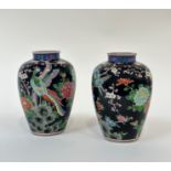 A pair of Japanese porcelain vases, early 20th century, of baluster form, each painted with a