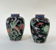 A pair of Japanese porcelain vases, early 20th century, of baluster form, each painted with a