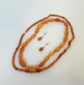 A butterscotch amber necklace, of graduated beads; together with an amber bead necklace of smaller