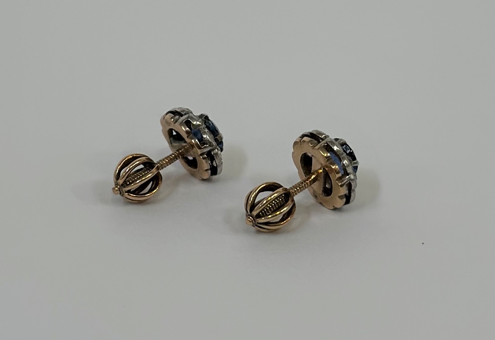 A pair of sapphire and diamond stud earrings, each with round-cut sapphire claw-set within a band of - Image 2 of 2