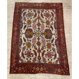 A North Indian Amritsar rug, the ivory field decorated with open floral design within a deep red