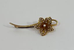 A 15ct gold and seed pearl floriform brooch, the petals set with seed pearls on a knife edge bar