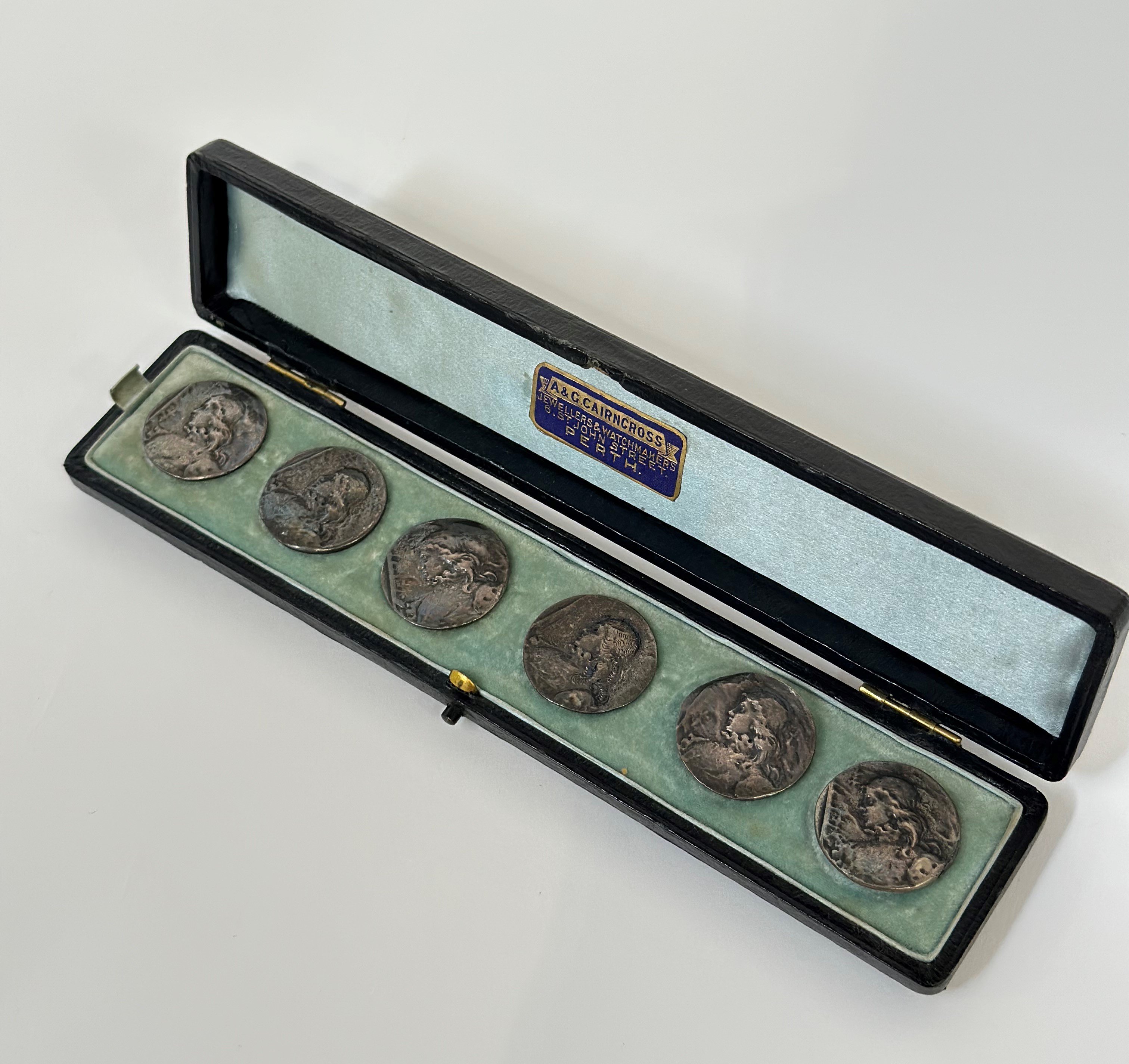 A cased set of six Edwardian silver buttons, Nathan & Hayes, Chester, 1901, in the Art Nouveau